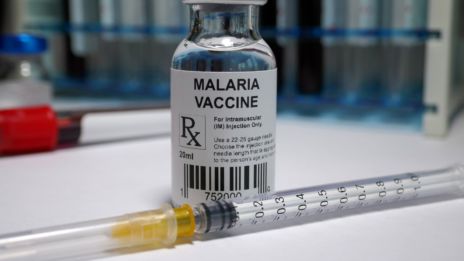 A vial and syringe representing a malaria vaccine used in endemic regions abroad