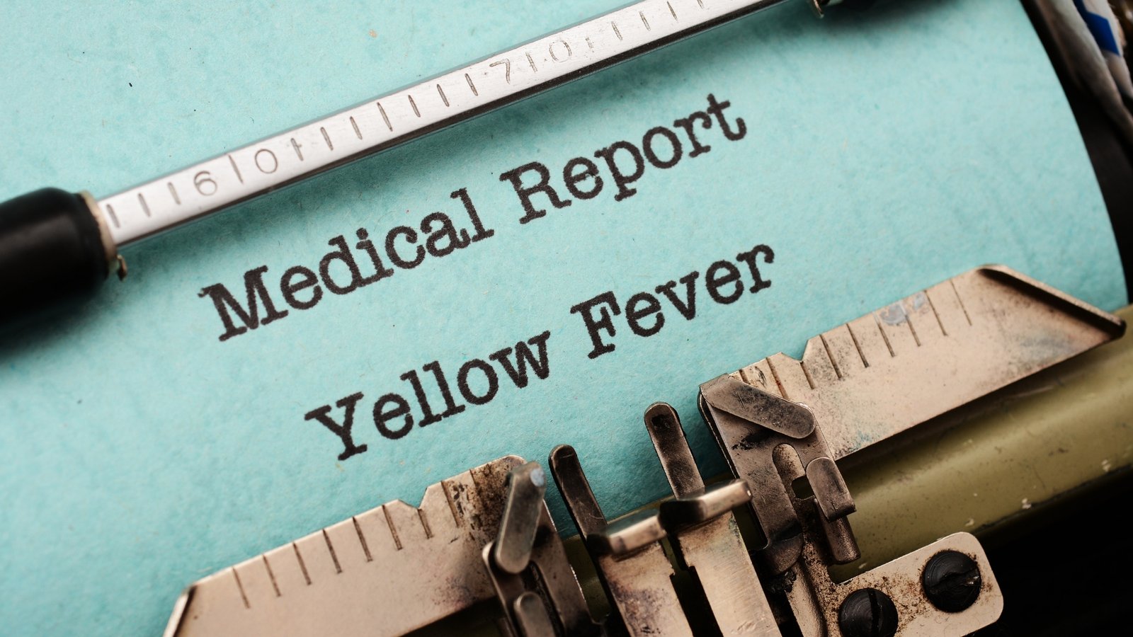 A yellow fever medical report being typed on a typewriter
